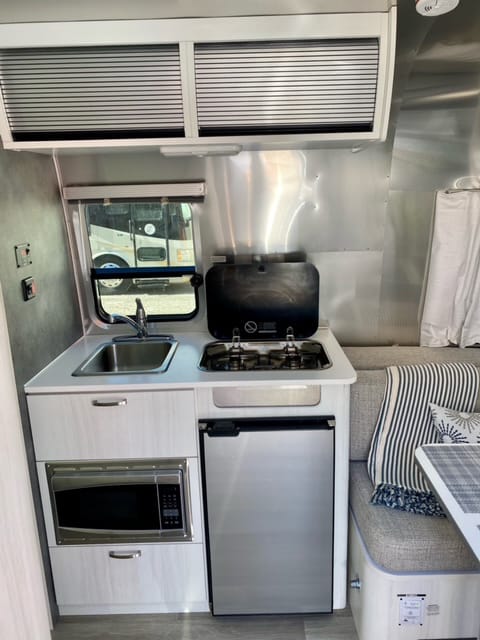 Dual propane burners, an AC/DC fridge and AC microwave allow you to easily cook on the go.