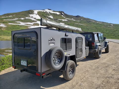 Here you will see our trailer hooked up and ready to tow. You can see lots of windows, the batwing awning, and spare tire kit.