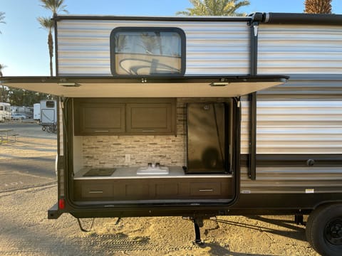 half kitchen, stove, sink and small refrigerator