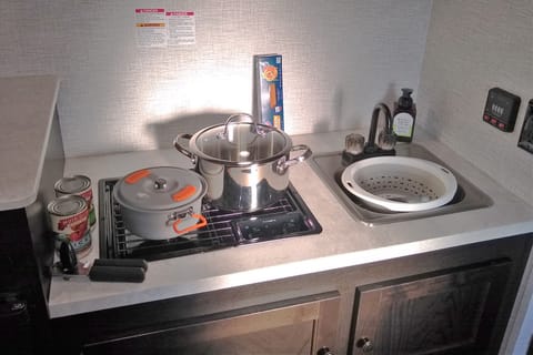 Fully-equipped kitchen, 2-burner stove, sink, and storage