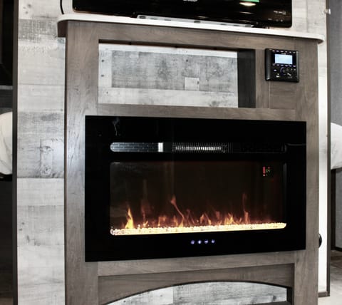 The fireplace is excellent- it can add warmth or ambience to your trip. You also see the quick access to interior/exterior Bluetooth speaker controls.