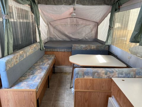 Large full popout bed. Kitchen table and chairs. This is the dinette fold down bed. The side couch also folds down to a single bed. 