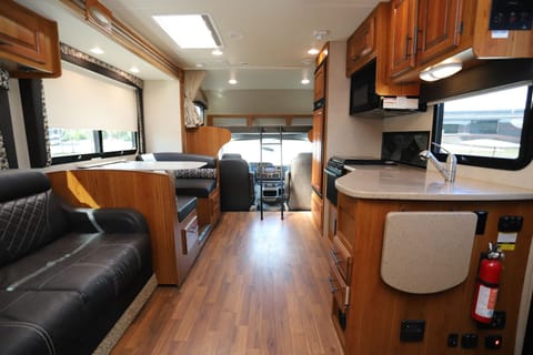 View of interior living space from just inside entry door.  Plenty of seating, spacious kitchen, and kids love the bunk over the cab!