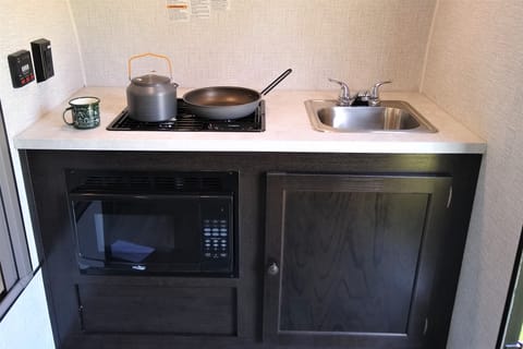 2-burner stove, microwave, and sink. Stocked with all the serving, eating, and cooking utensils you'll need!