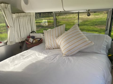 View from the foot of the bed. Large storage cabinets above the windows make it easy to bring whatever you need on your journey