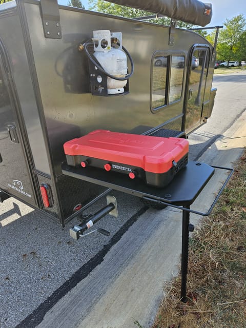 Kitchen Package (Optional add-on) includes a side-table, stove, propane. Also included, but not pictured: pot, 2 skillets, plates, bowls, cups, and utensils for 4 people.