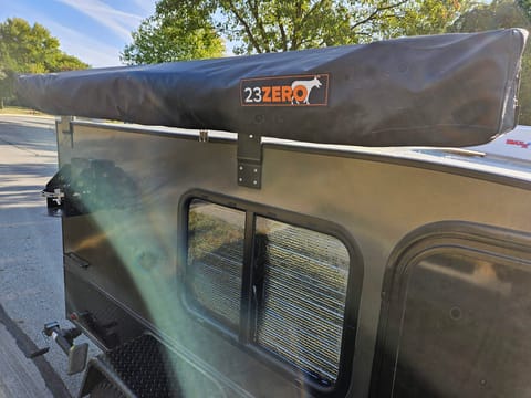 Included is a 270 degree awning that can fit a picnic table under. Perfect for shade or coverage from the rain. The awning wraps around the back of the trailer to allow for access to the galley.