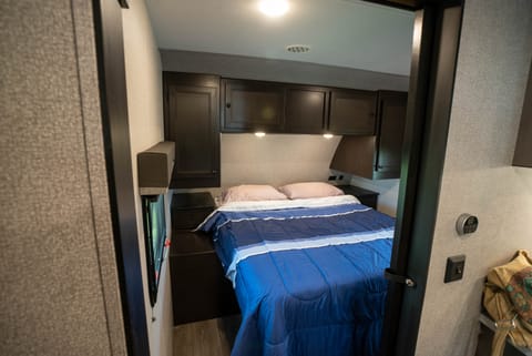 Full size walk-around queen bed plus black-out shades and a pocket door mean you can get your rest when you need to!