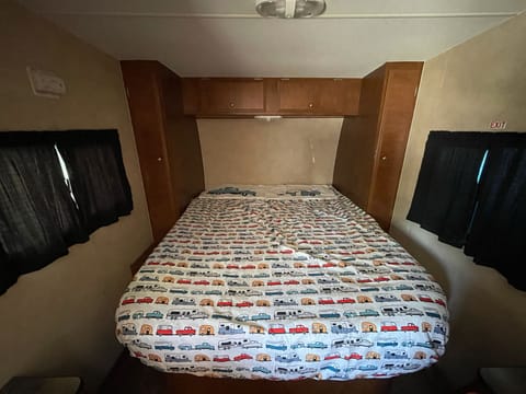 Queen size bed with wardrobes and overhead storage
