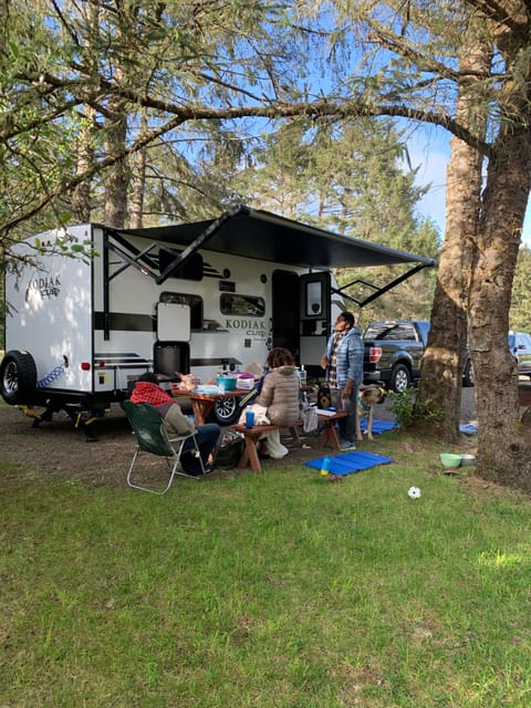 with a 14ft retractable awning, make any space a cozy gathering spot. Be sure to utilize the outdoor Bluetooth speakers to create the perfect atmosphere. Also take note of the coiled blue hose on the rear, useful for washing off muddy shoes or dogs.