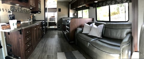 Our 2018, very modern home on wheels still smells new! Look how much light there is all the way to the back in the bedroom.  The master bed is fluffy with wonderful linens. We have lots of included extras.