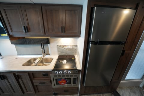 Kitchen: large fridge, sink, roomy counter top, stove