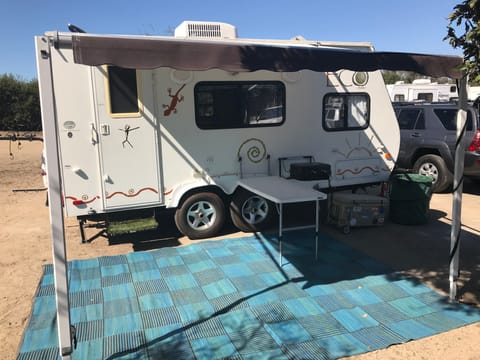 The trailer has Thule attachable table and BBQ grill and outside shower.  Also large ground mat