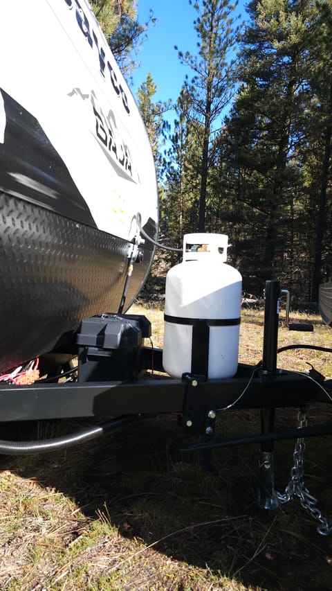 Full propane tank provided - this powers the furnace, the stove, and the tankless water heater
Battery - powers the radio, lights, slide out, awning, AC fan, outlets, water pump and refrigerator