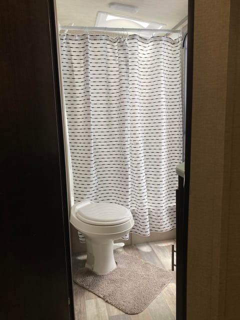 Large shower and roomy bathroom with two storage cabinets.  (Shower and toilet available at full hook up sites only).