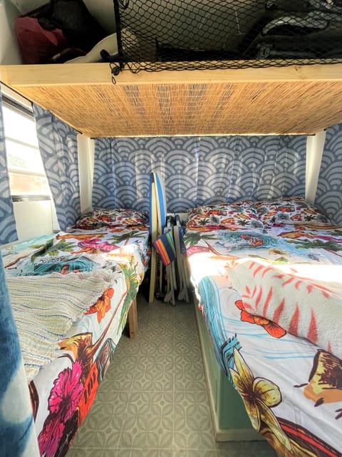 The master bedroom is at the back of the vehicle. It's beachy, breezy, and still private. 