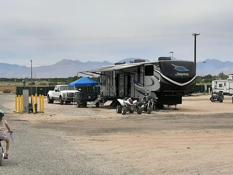 This photo shows the RV in use with all slides, awnings and toys out.  