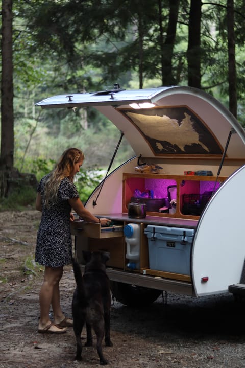 Our full outdoor galley comes equipped with plenty of storage, a yeti cooler, butane stove, and detachable side table for extra counter space.