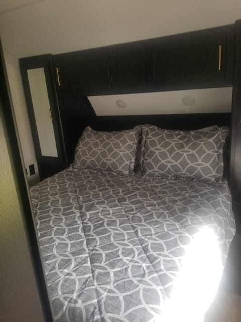 Queen bed with 2 closets , phone charger and end tables ` storage under bed