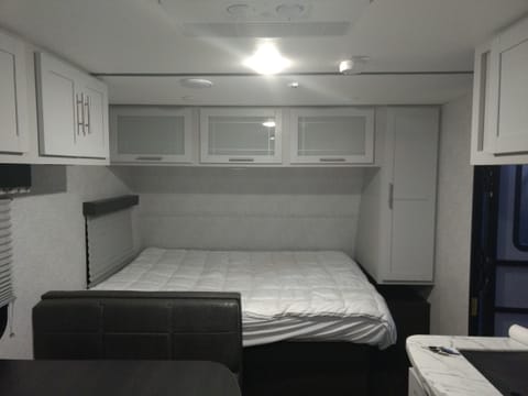 RV size queen bed with plenty of storage available.