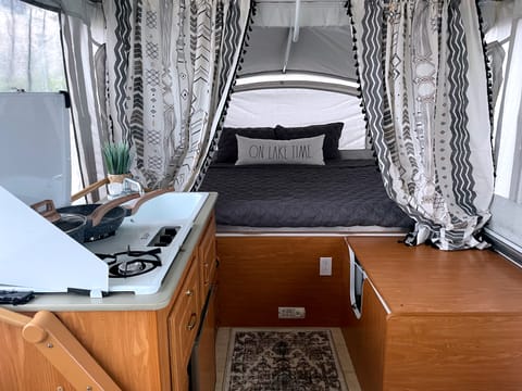 This is one of the King Beds on the right side of the trailer, next to the Kitchenette and the Shower & Toilet which can be seen folded down her on the right of the photo!