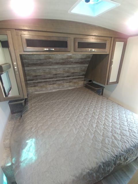 Front sleeper King Bed with large storage on sides and above bed. 