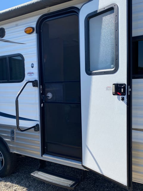 getting in and out of this camper is a breeze with the oversized grab bar and step with nonslip surface. The screen door helps let in the air and the view.