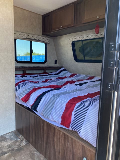 Our comfortable queen bed is just to the right of the door and next to the bathroom.  includes two blackout shades at the head and put up the bed, and an optional front window you can open and close from the outside.