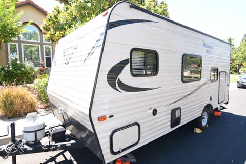 Left Side of RV, Windows, Storage, heater, fresh water connection, electricity connection