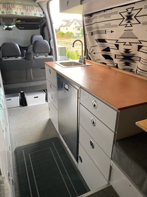 Galley with fridge, sink, and cabinets