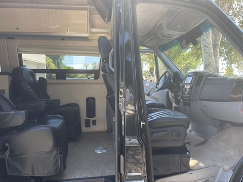 Sliding door access and also looks into passenger door. Adjustable leather seating. Front seats recline flat, also rotate. Table goes between seats.