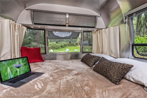 Queen size bed with wrap around windows