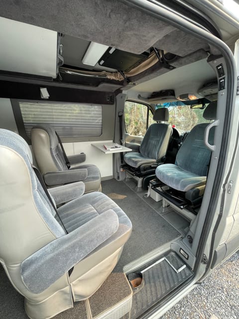 Front seats swivel to face towards the other seats (captains chairs).  The side table fold out for easy use. 