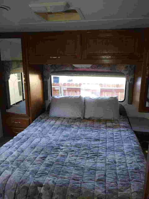 King size master bedroom in the back of the RV with privacy door from rest of coach. 