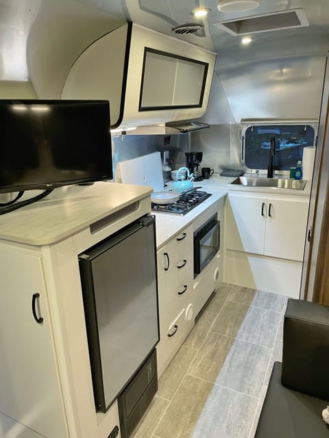 The spacious kitchenette with gas range, sink, mini fridge, and microwave is sure to please your inner chef!