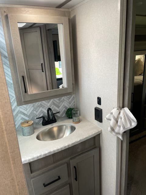 Shower with a bench seat, great water pressure, cabinets to store towels and Toiletries. 