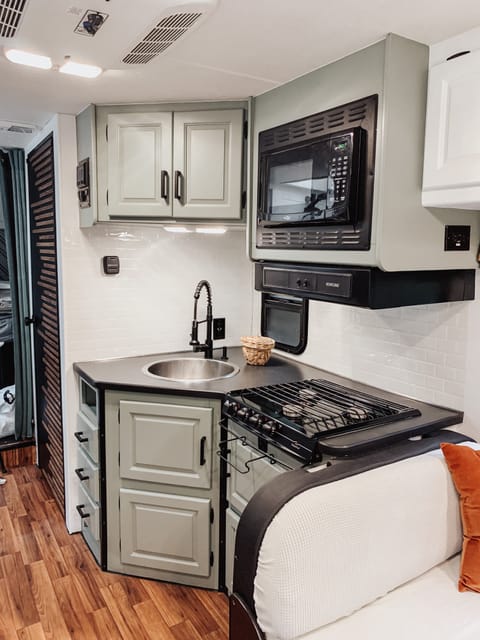 Cooktop, microwave and sink in the kitchen (fridge on the other side)