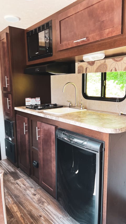 Kitchen - Sink, Microwave, Dometic Fridge and 2 Burner Cook Top. 