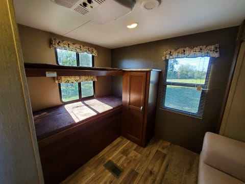 The left side of the bunkhouse has 2 bunk beds that can hold 350lbs each. The cabinet has a ton of storage and is wired for both electric and cable. Great gaming area for the kids.