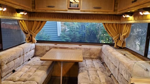 Dining table and passenger area with wrap around view. Converts to a king size bed or two twin beds.