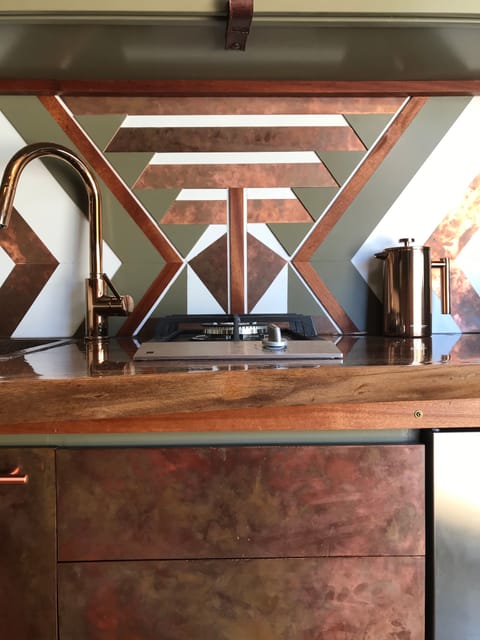 Stove and sink surrounded by copper 