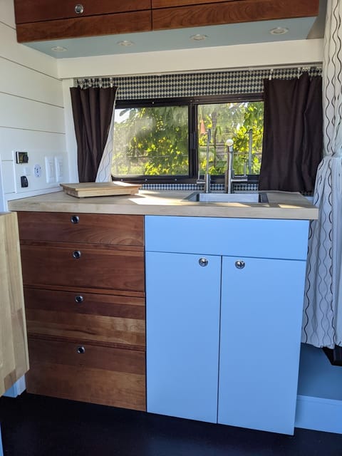 Hot and Cold running water with the bonus of filtered drinking water. Cabinets are appointed with reclaimed cherry millwork.