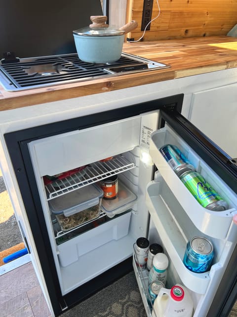 The roomy fridge has space for several days worth of supplies. With the freezer compartment you can enjoy ice cream off grid! Cool!