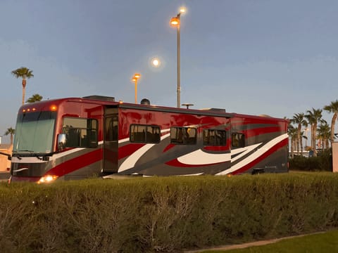 Exterior view of coach at dusk.