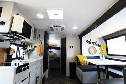 The interior has a dinette, full kitchen, bathroom and 2 full sized bunks