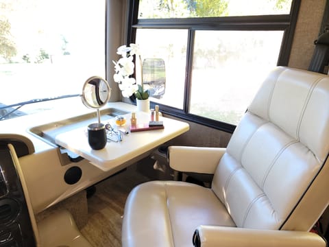 Front passenger seat comes with pull out desk. Perfect for catching up on work or doing your makeup (makeup just for show & not included with rental)