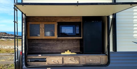Outdoor kitchen with microwave