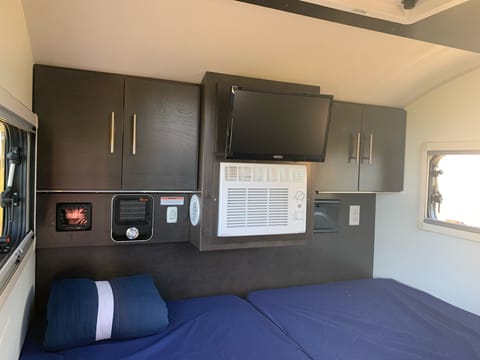 TV with DVD player, Heater and AC with thermostats. Bedsheets and quilt provided with rental.