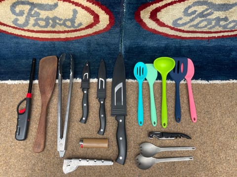 This is the basic kitchen utensil set -- sporks, a pot grip holder, a few knives, wine bottle opener and some silicone cooking spoons and spatulas.