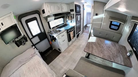 Kitchen has a sink, 3-burner stovetop, oven, fridge, freezer, and microwave. Dinette slides out 1-2 feet more than pictured.